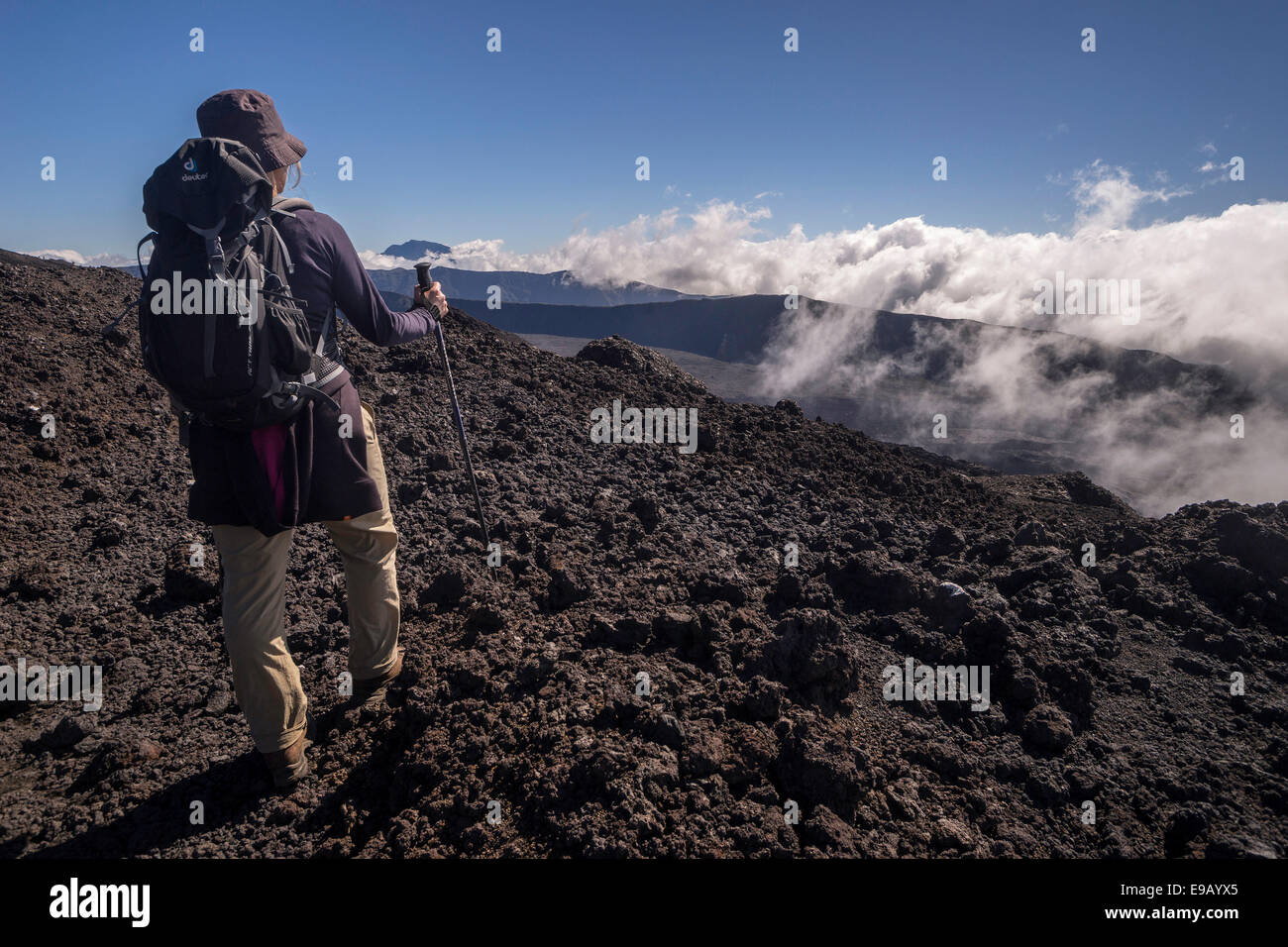 Hiker on the Piton de la Fournaise volcano with views of the Piton des