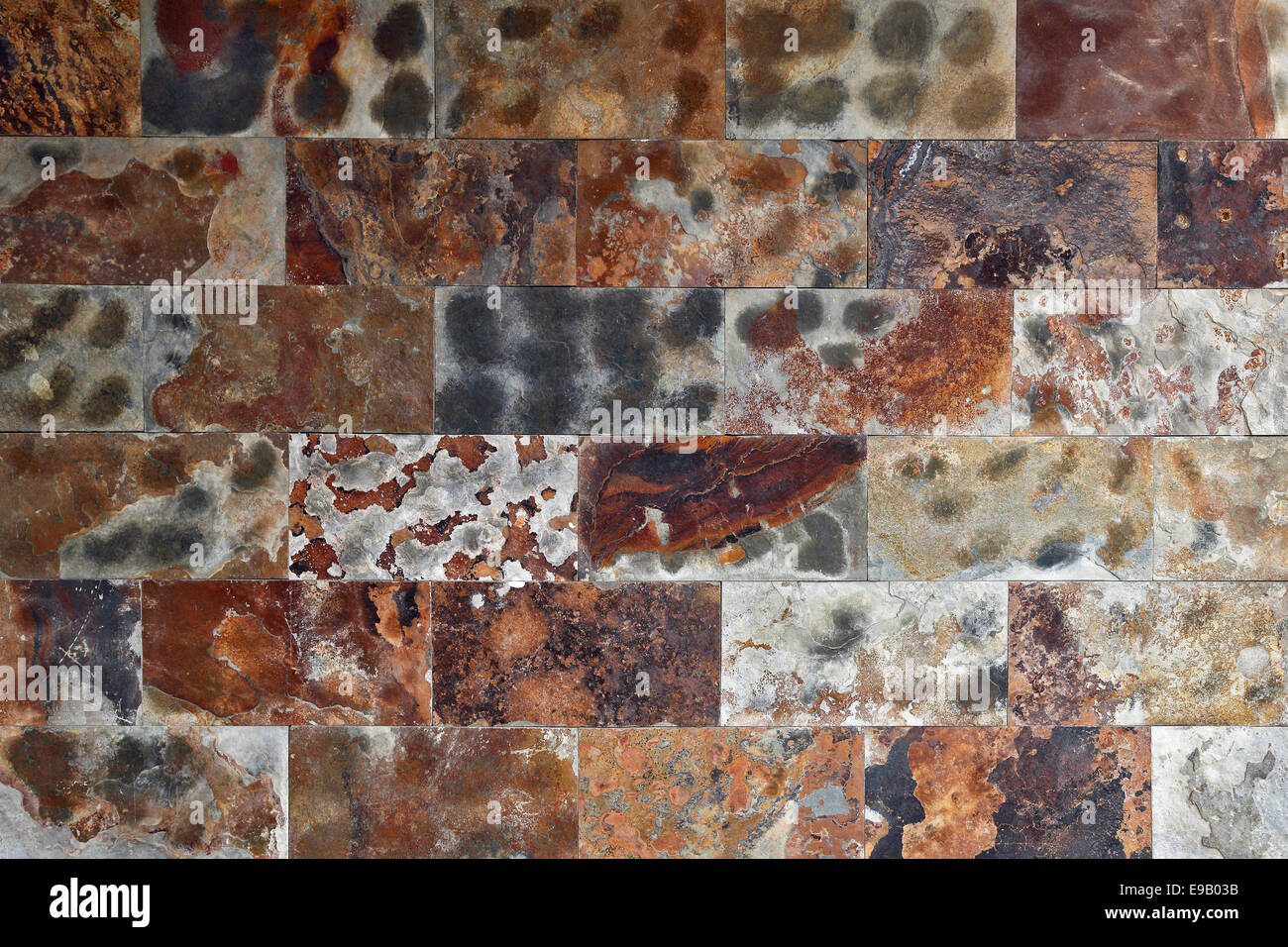 Wall, colourful polished natural stone blocks, various types of rock Stock Photo