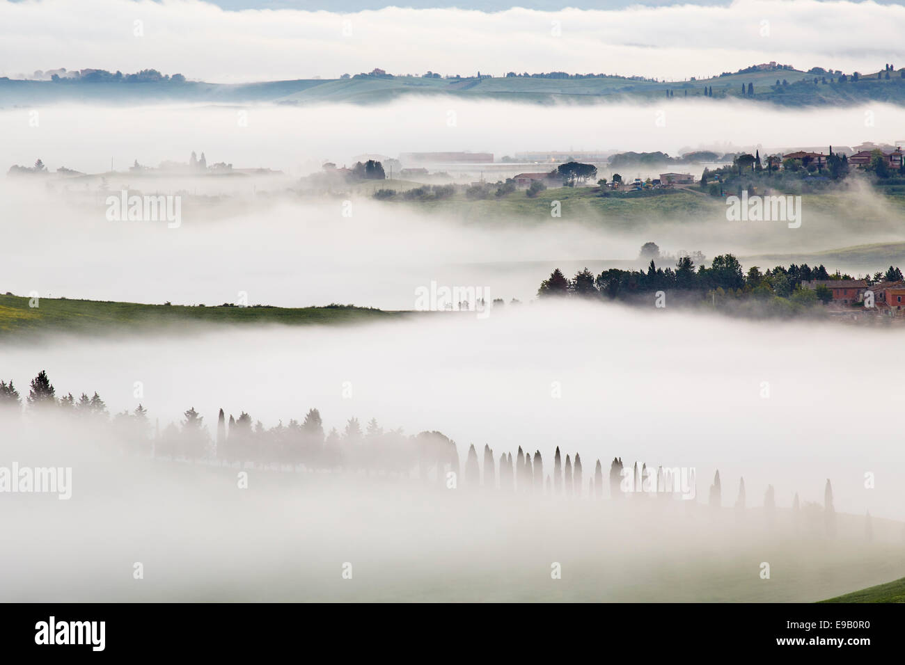 Fog in the valleys of the Crete Senesi, Chiusure, Arbia, Tuscany, Italy Stock Photo