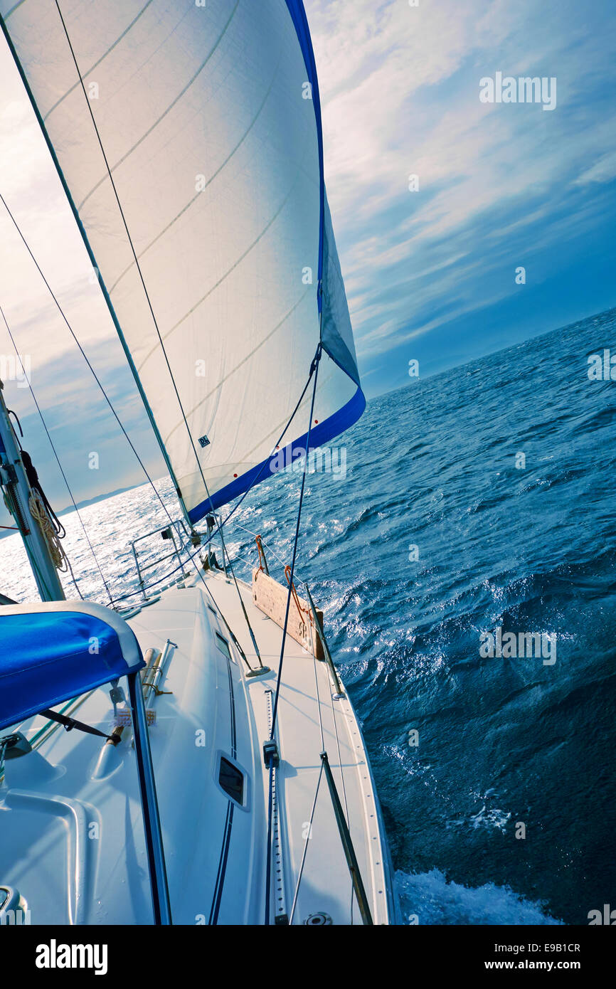 A yacht sailing downwind with a full genoa. Stock Photo