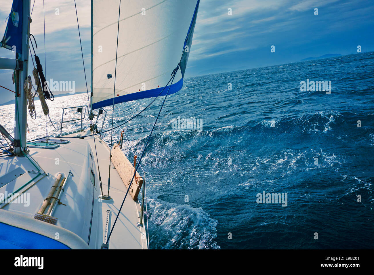 A yacht sailing downwind with a full genoa. Stock Photo