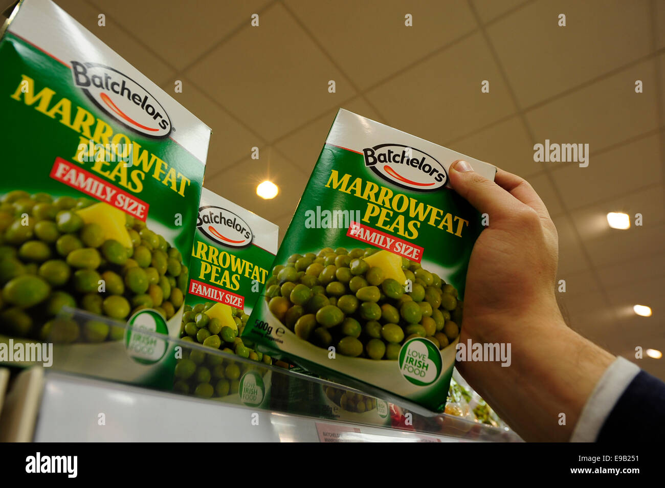 Batchelors marrowfat peas been taken from the shelf (Newscast)(Model Released) Stock Photo