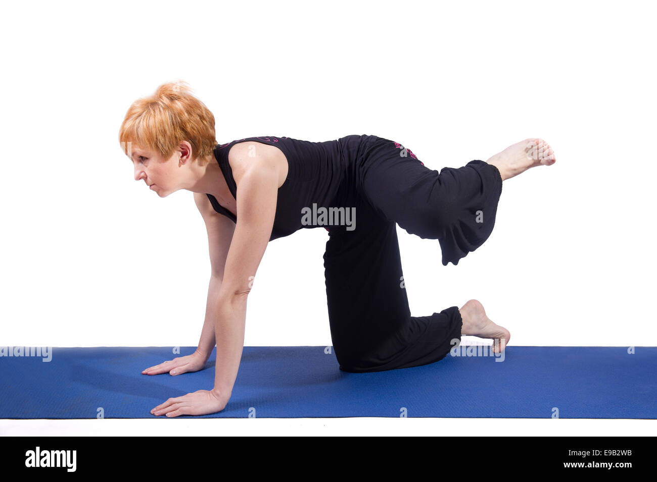 Woman doing sports on exercise mat Stock Photo