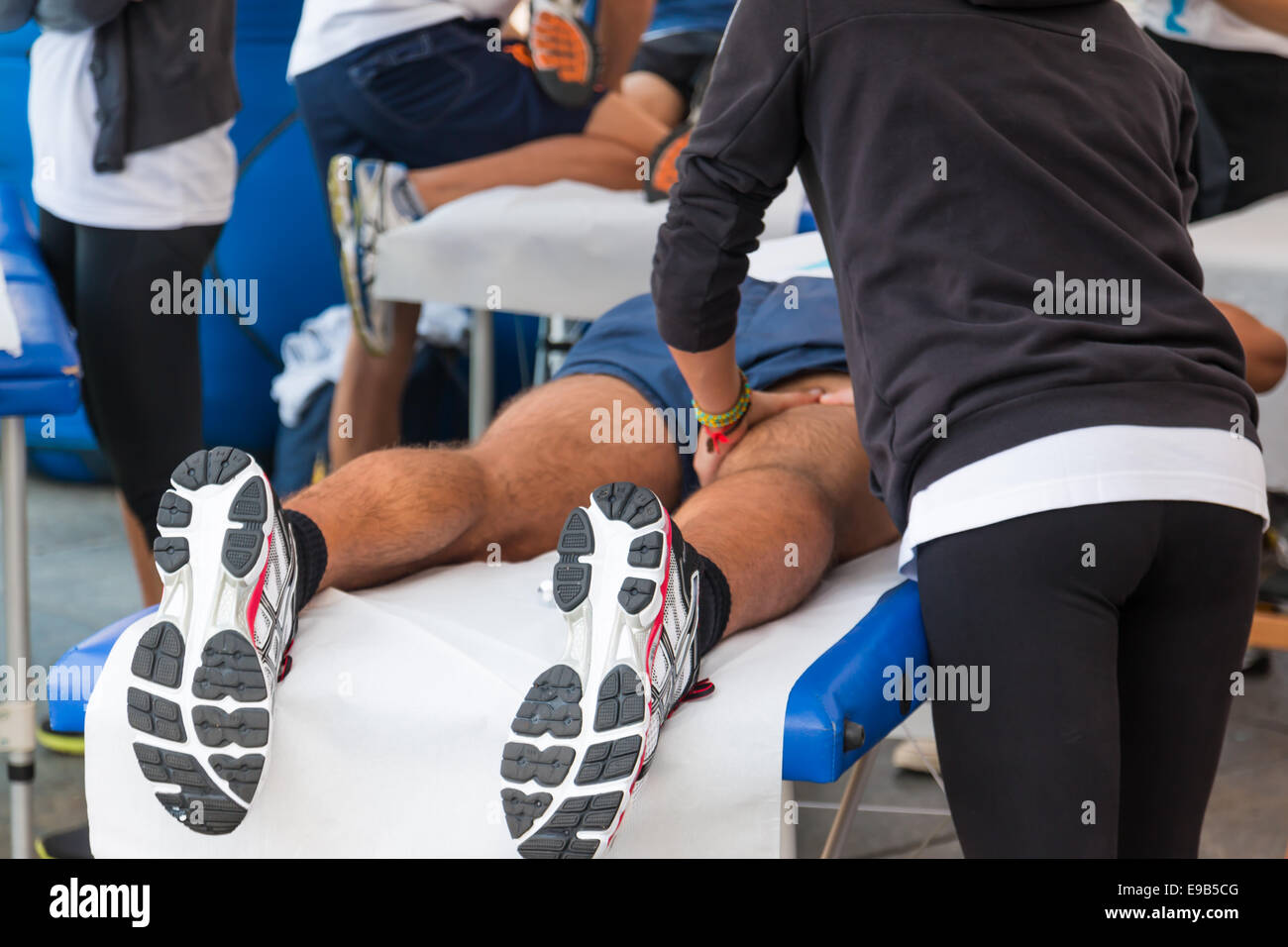 athletes relaxation massage before sport event, marathon muscles massage Stock Photo