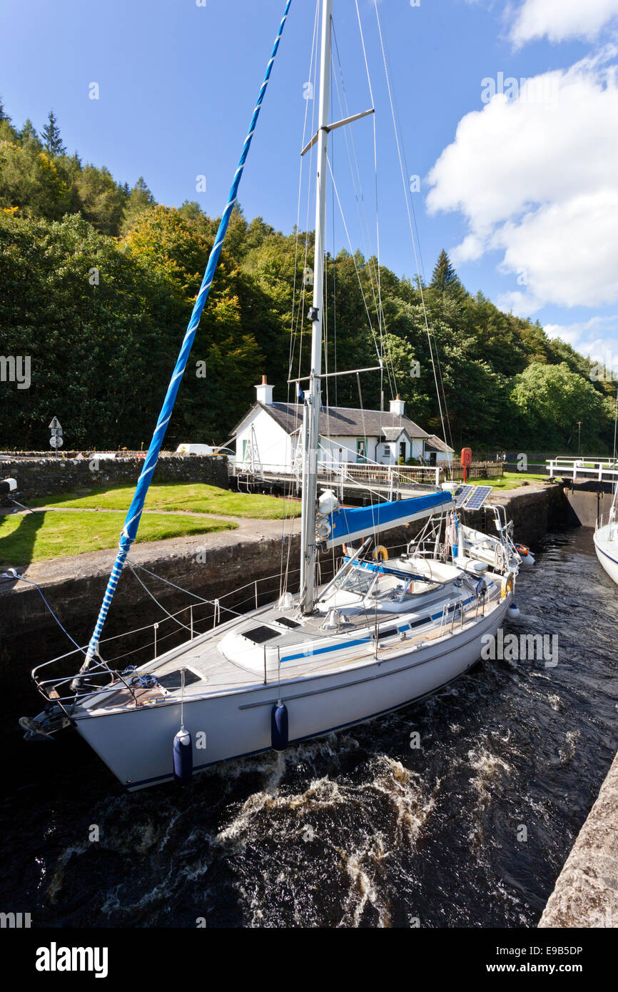 The Crinan Canal - A yacht negotiating Lock 11 at Dunardry Bridge, Argyll & Bute, Scotland UK Stock Photo