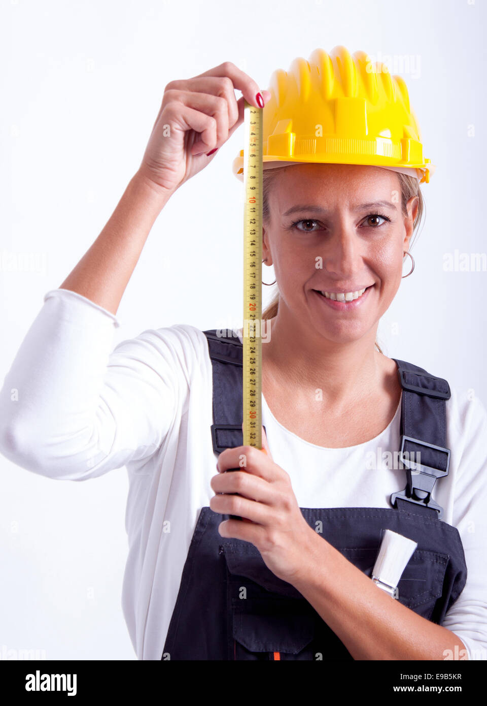 Female construction worker with tools on white background Stock Photo ...