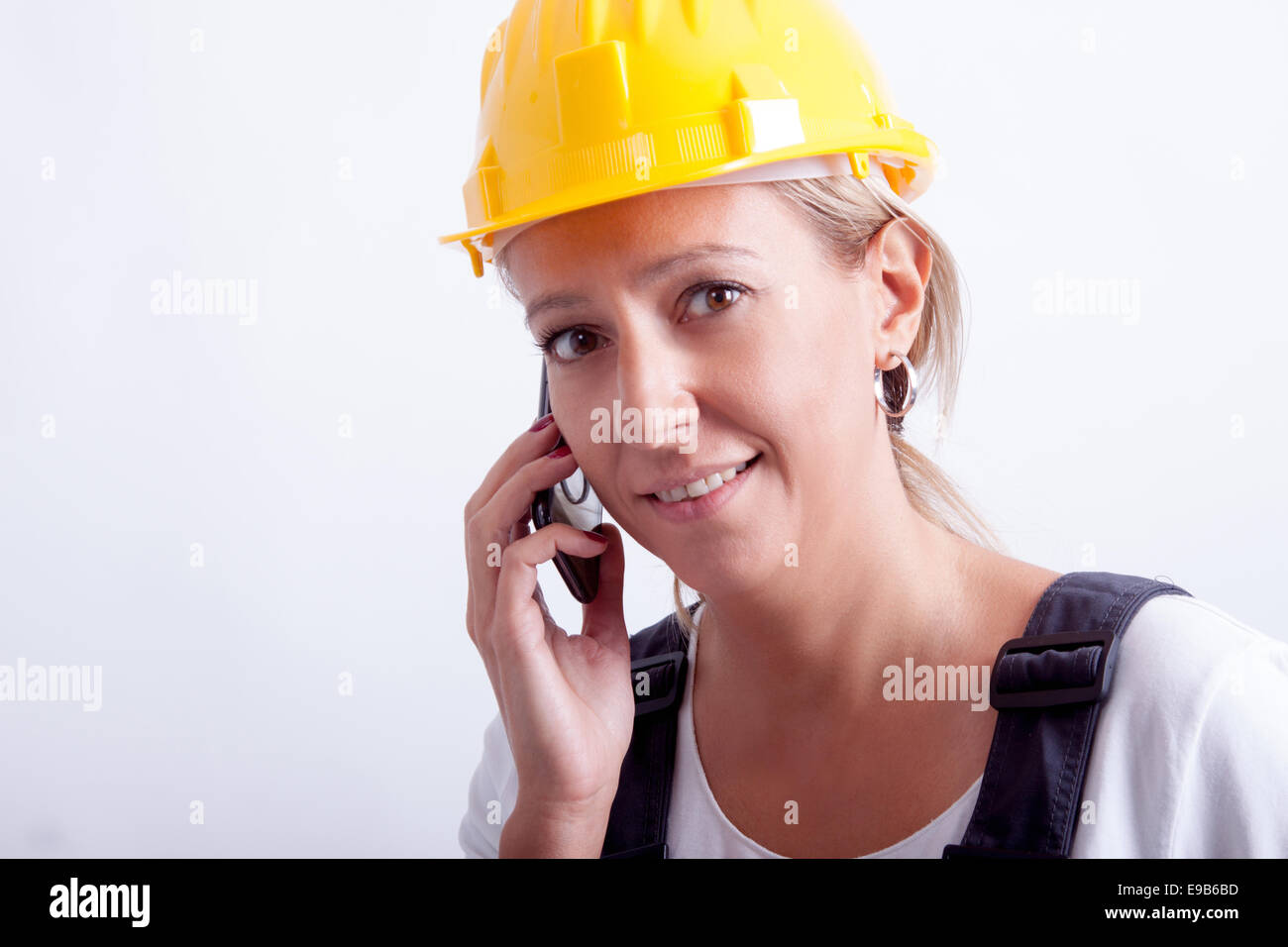 Female construction worker with tools on white background Stock Photo ...