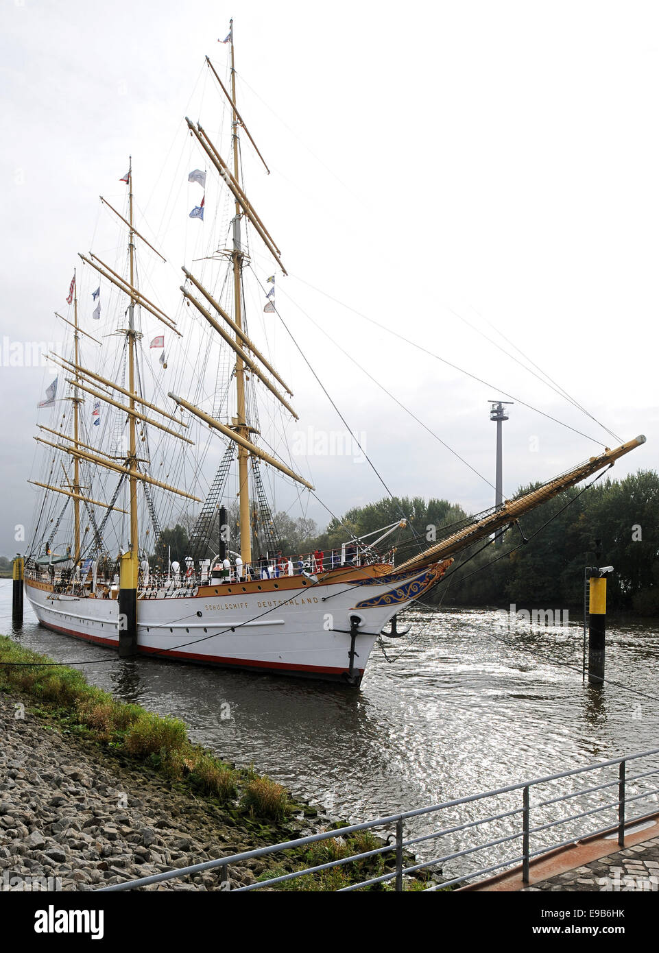 Bremen, Germany. 23rd Oct, 2014. The white tall ship 'Schulschiff Deutschland' (lit. school ship Germany) leaves its berth in Bremen, Germany, 23 October 2014. The last existing German full-rigged ship is taken to a wharf in Bremerhaven for repair works. The hull of the 87 year old ship has been damaged by rust. The repair works will cost about one million Euro. Photo: Ingo Wagner/dpa/Alamy Live News Stock Photo
