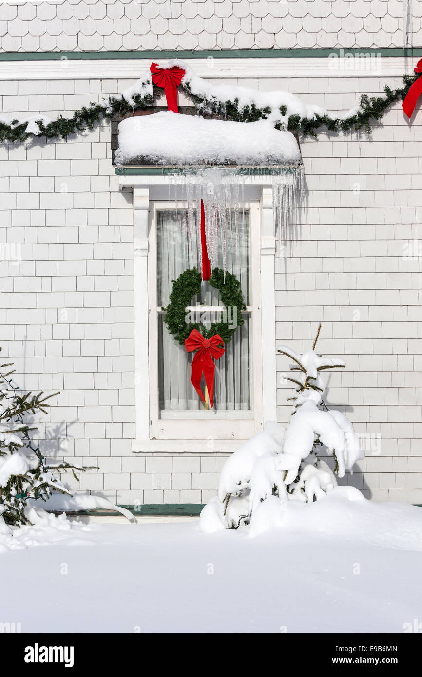 Christmas wreath and garland decorating an older style home. Stock Photo