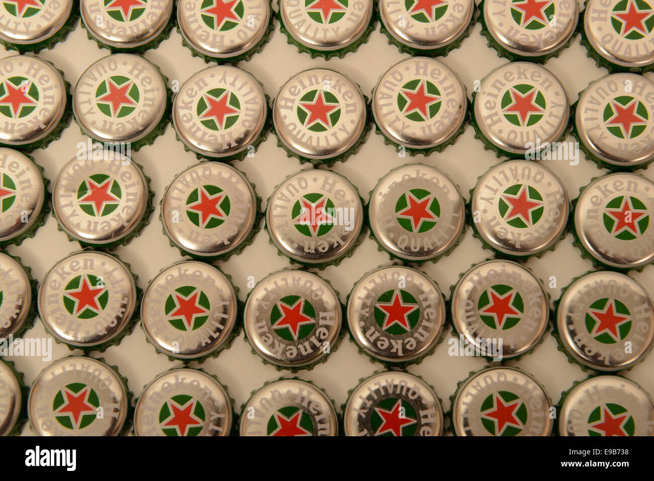 Rows of Heineken bottle caps against a white background Stock Photo Alamy