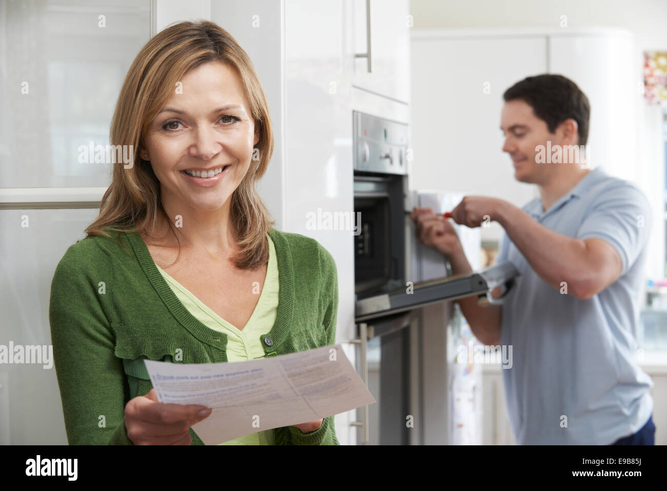 Satisfied Female Customer With Oven Repair Bill Stock Photo