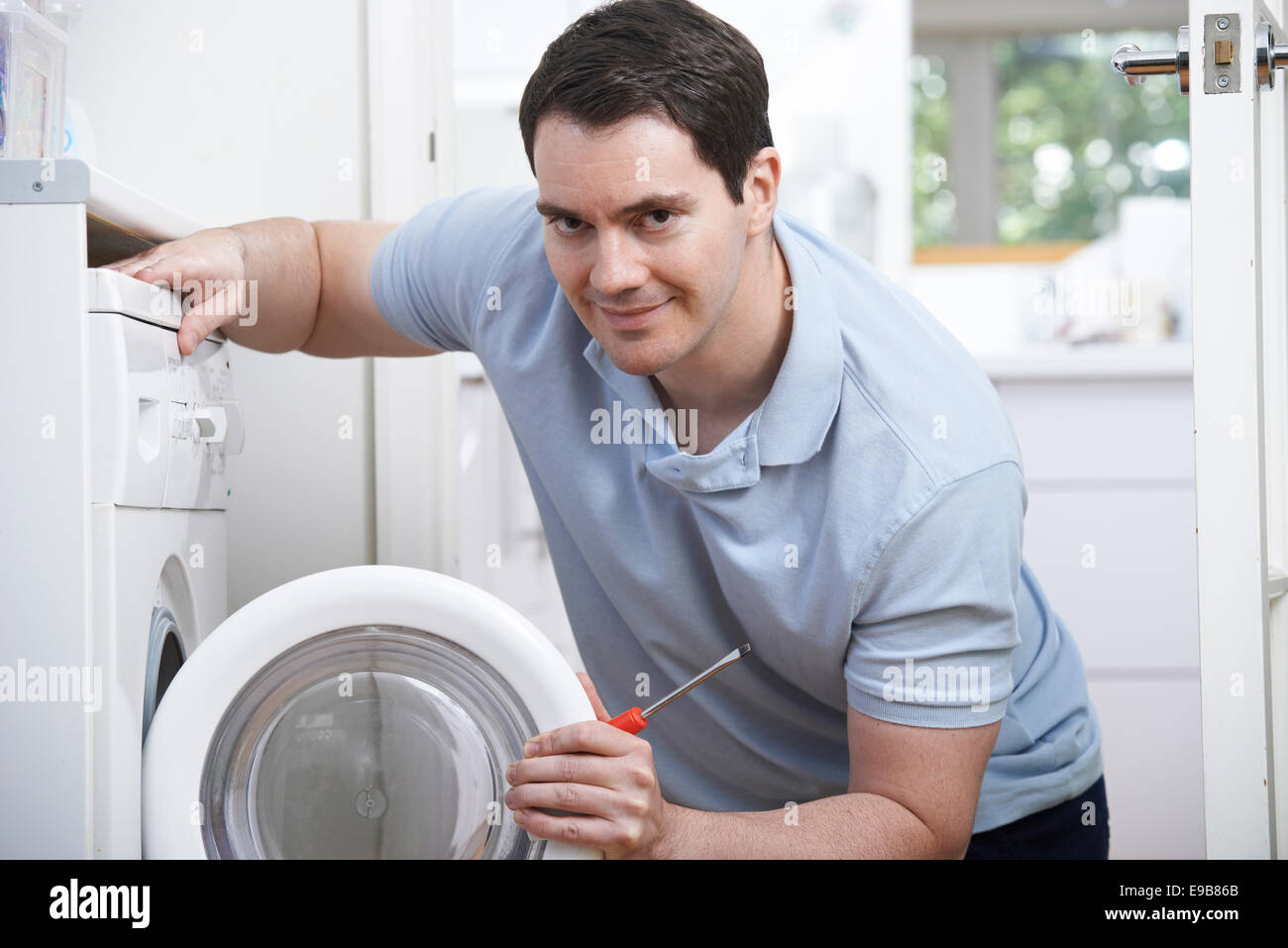 Engineer Mending Domestic Washing Machine Stock Photo Alamy