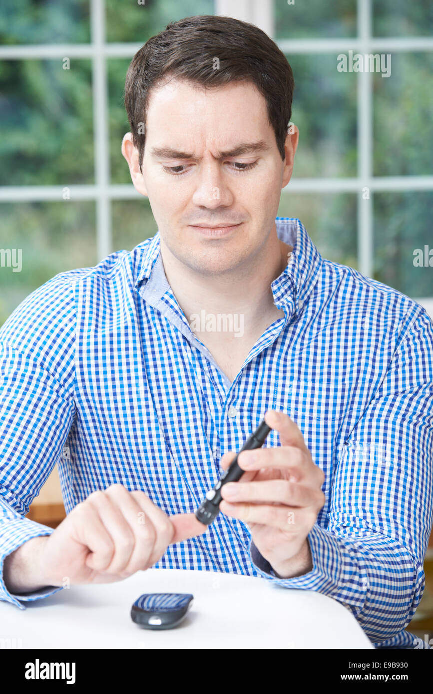 Man Checking Blood Sugar Level At Home Stock Photo Alamy