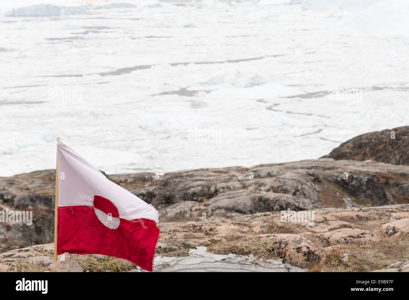 Arctic landscape in Greenland around Disko Island with icebergs and greenlandic flag Stock Photo
