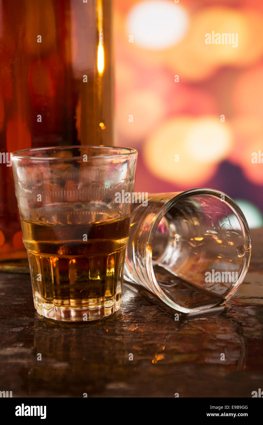 glass of rum whiskey over defocused lights background Stock Photo Alamy
