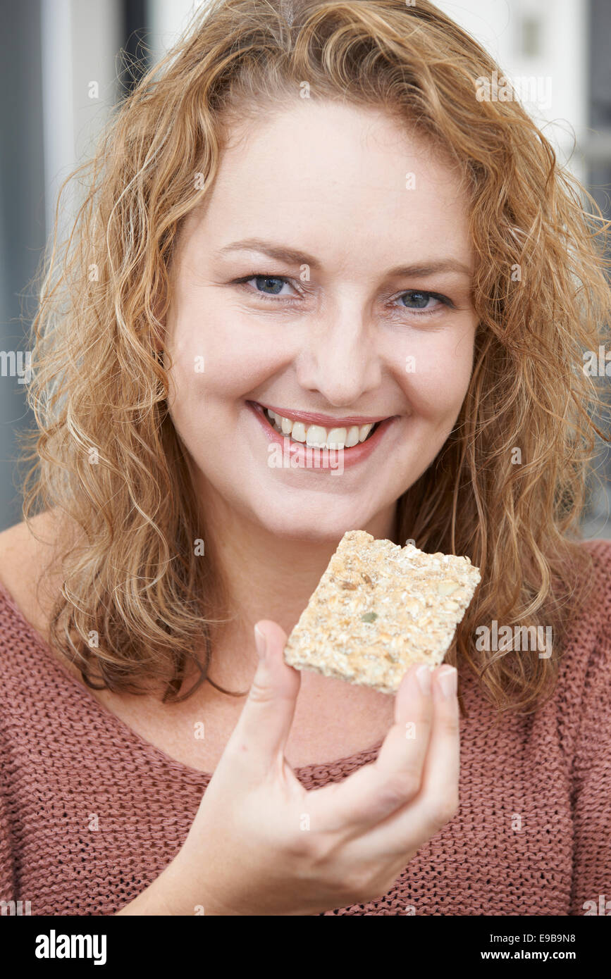 Woman On Diet Eating Crispbread At Home Stock Photo