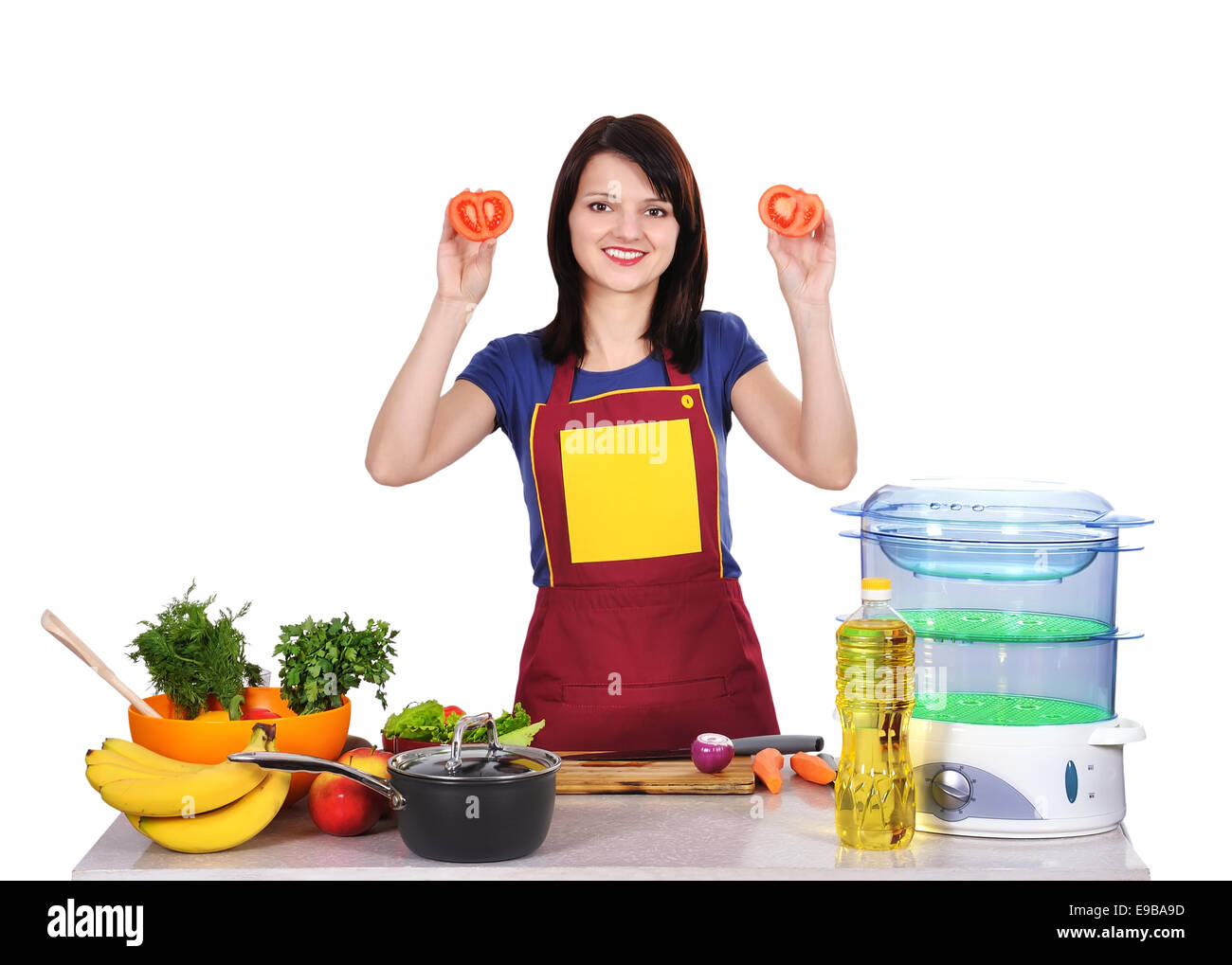 young housewife holding tomato in hand Stock Photo