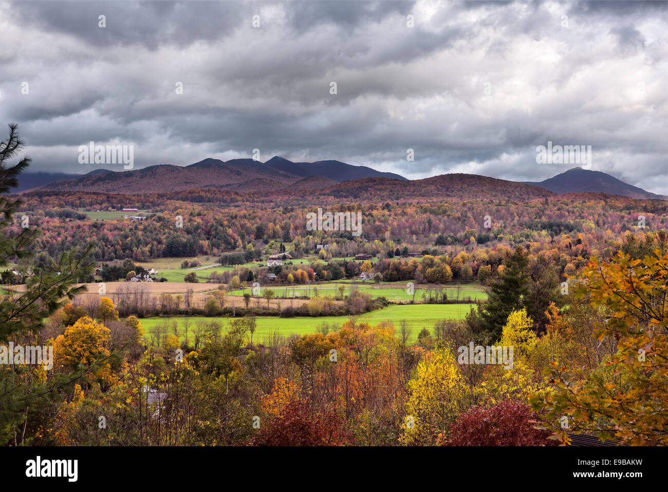 View of Stowe valley and Sterling Range from Brush Hill Vermont USA in Autumn with red and yellow leaves on trees Stock Photo