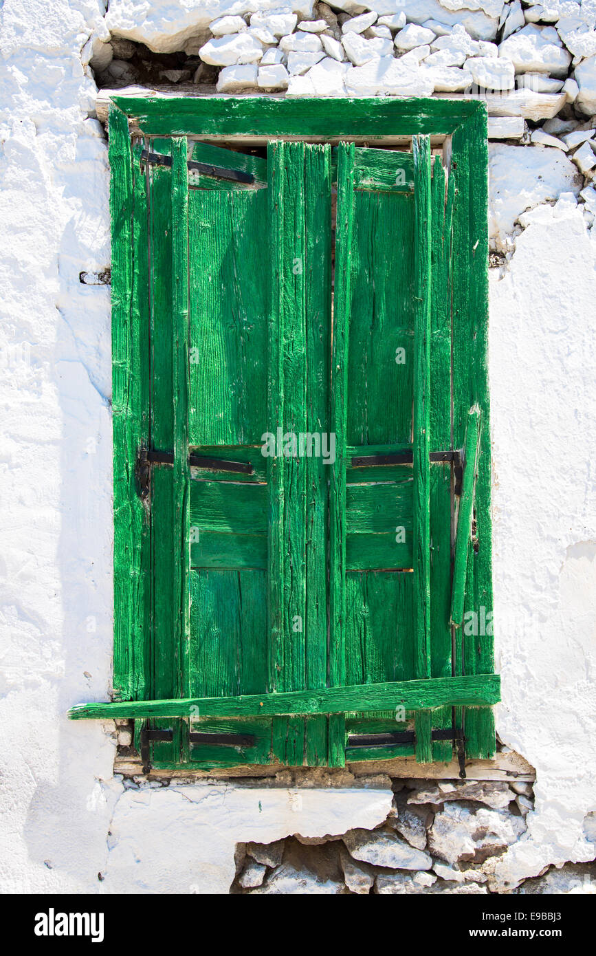 colourless green shutter at ruin at tripiti in milos greece Stock Photo