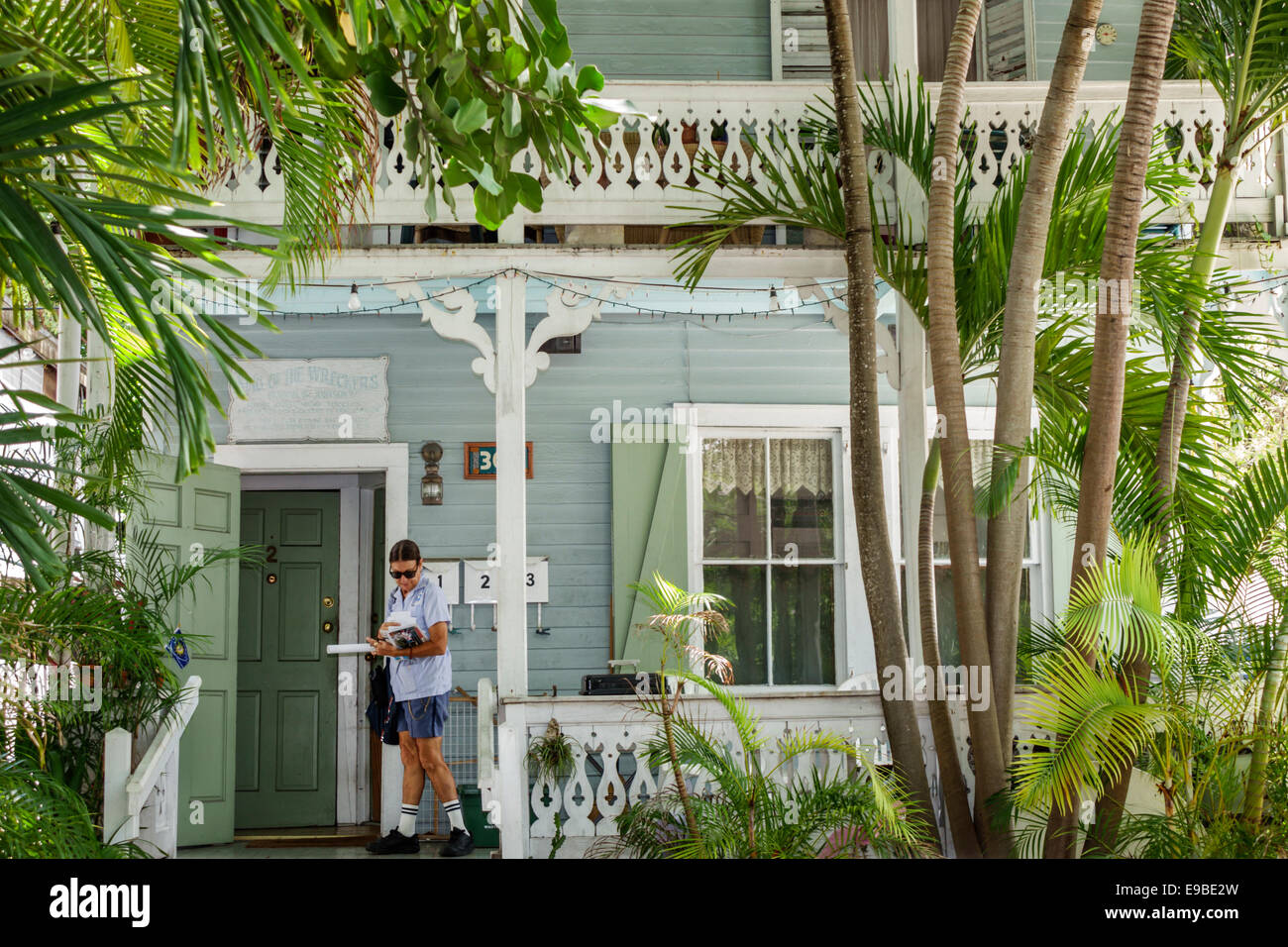 Key West Florida,Keys Whitehead Street,adult adults woman women female lady,mail delivery,postal,tropical landscaping vegetation,plants,trees,visitors Stock Photo