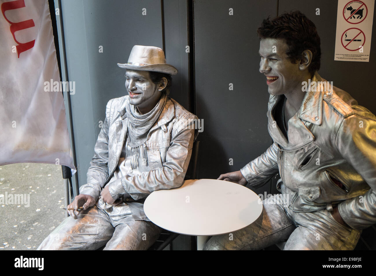 Stand still,motionless, street artists / performers having a rest and relaxation time taking a break at cafe, coffee shop,Paris. Stock Photo