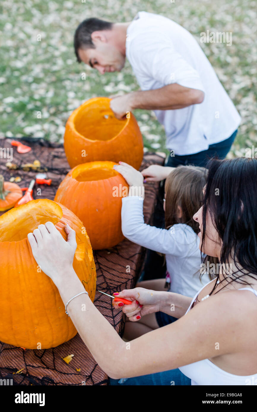 Carving big orange pumpkins for Halloween in late Autumn Stock Photo ...