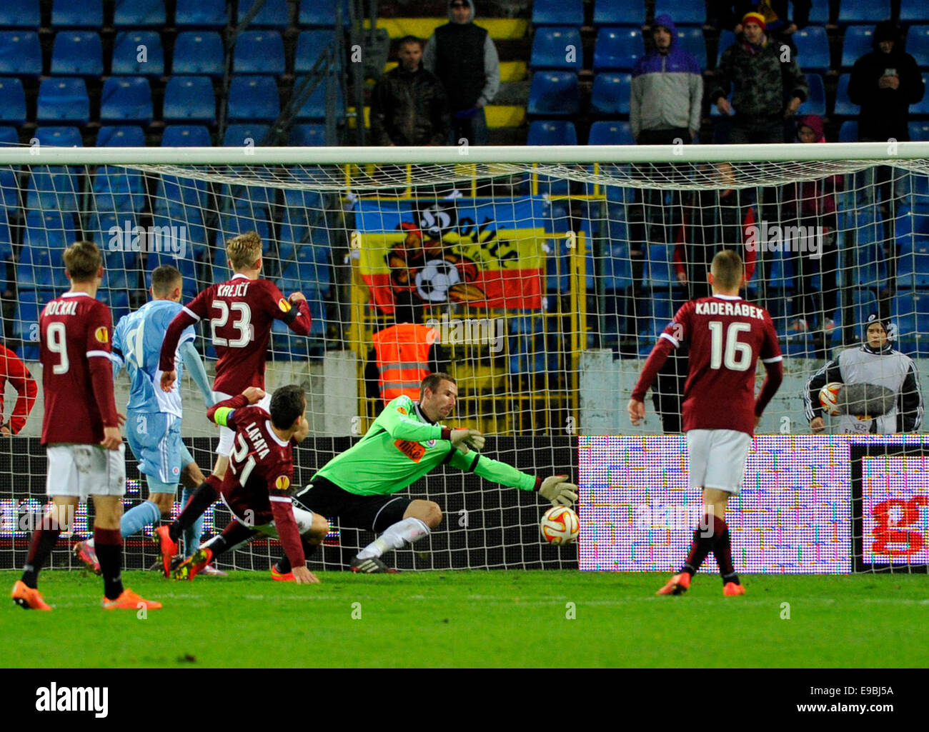 Bratislava, Slovakia. 23rd Oct, 2014. Sparta's David Lafata, fourth left, scores against Slovan's goalkeeper Dusan Pernis his side's first goal during the Europa League Group I match between Slovan Bratislava and Sparta Prague at the Pasienky Stadium in Bratislava, Slovakia, Thursday, Oct. 23, 2014. Sparta won 3-0 after the match had to be due to the ravages of visiting hooligans about 35 minutes interrupted. Credit:  Jan Koller/CTK Photo/Alamy Live News Stock Photo