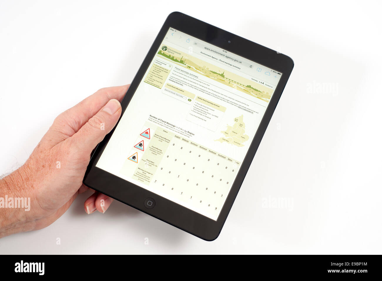 iPad with environment agency flooding app on screen checking for flood alerts Stock Photo