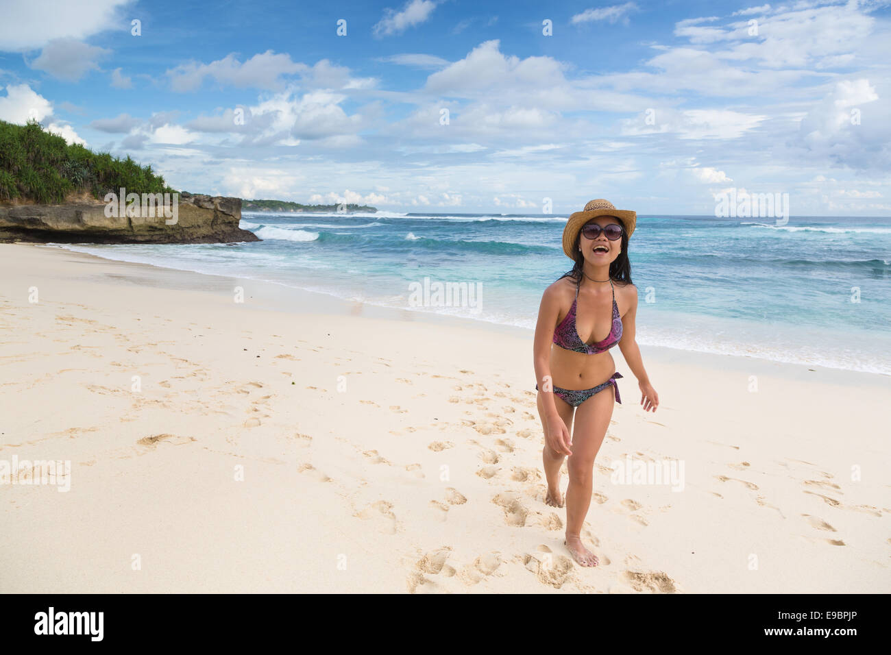 Young Asian woman walking on Lembongan beach in Bali in Indonesia on a sunny day Stock Photo