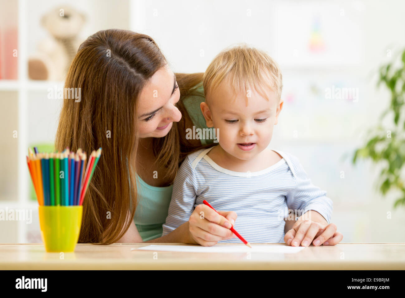 https://c8.alamy.com/comp/E9BRJM/mother-and-her-child-pencil-together-E9BRJM.jpg