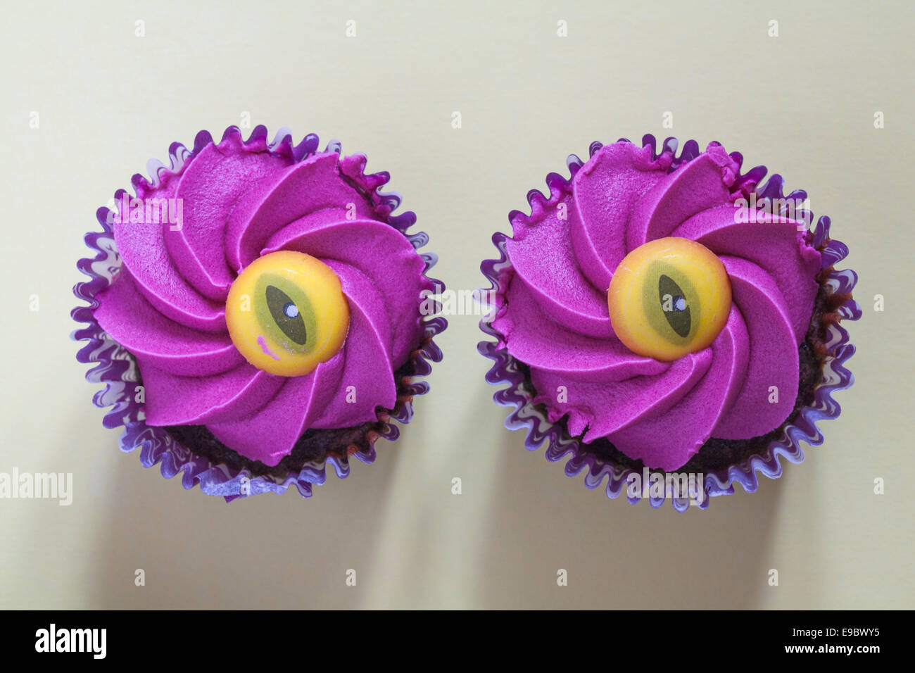 Looking Down On Tesco Halloween Evil Eye Cupcakes Isolated On Pale Blue Background Chocolate Cupcake With A Gooey Strawberry Jam Centre From Above Stock Photo Alamy