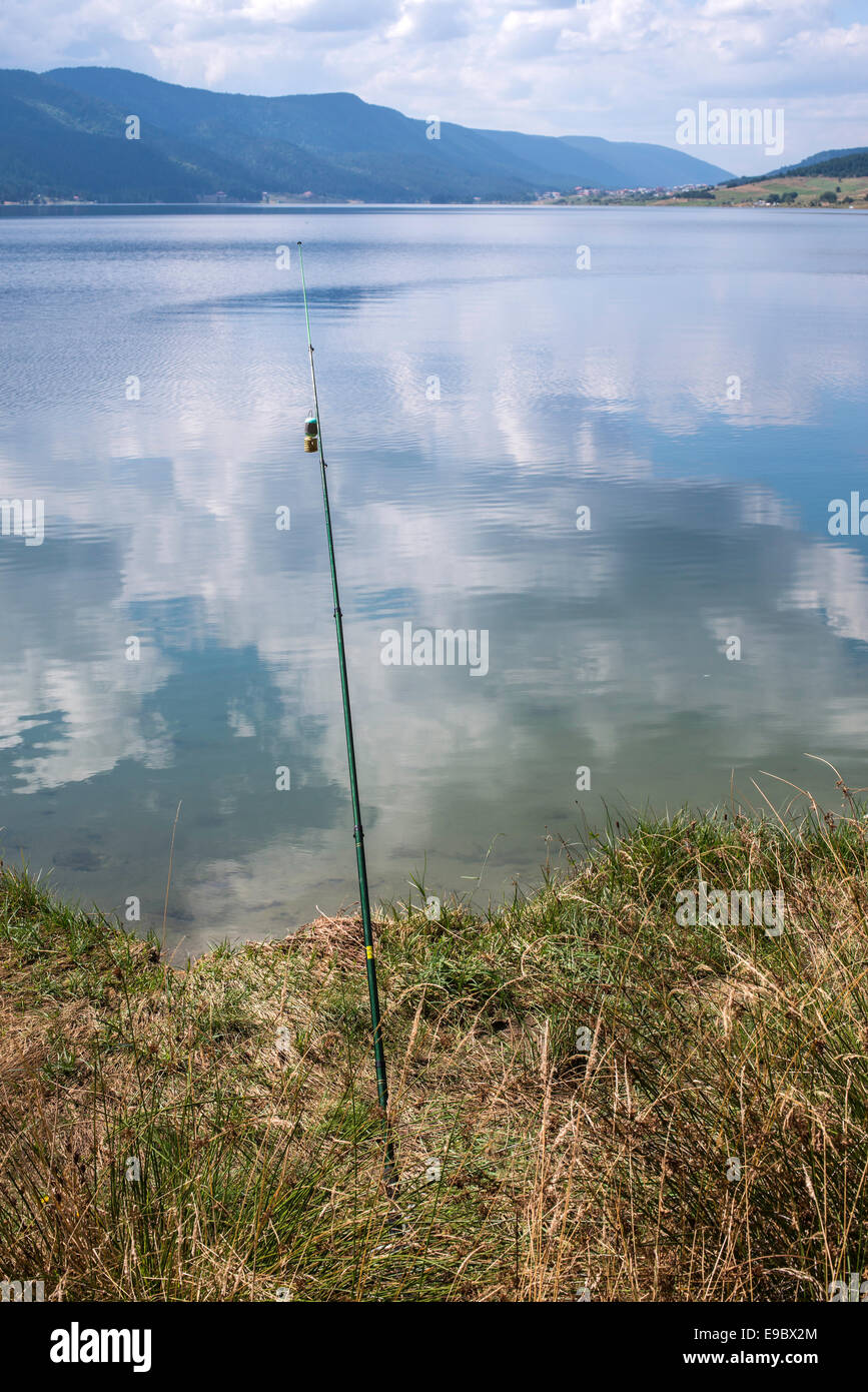 Fishing rods on a mountain lake Stock Photo
