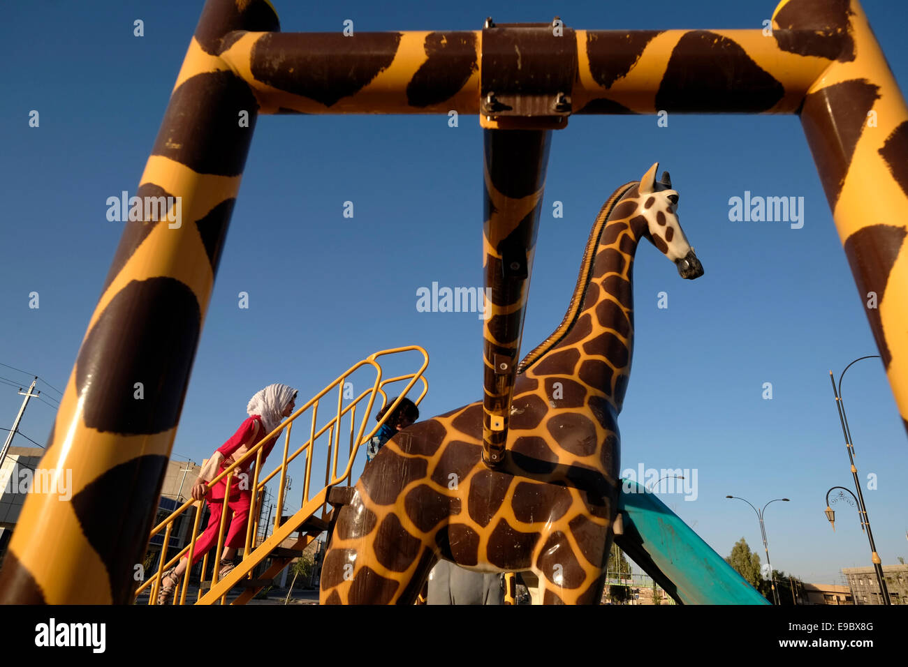An Arab Sunni girl playing in a playground in the city of Kirkuk in northern Iraq Stock Photo