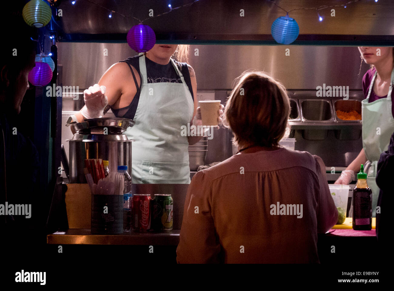 Outdoor catering stall serving hot drinks at night. Stock Photo