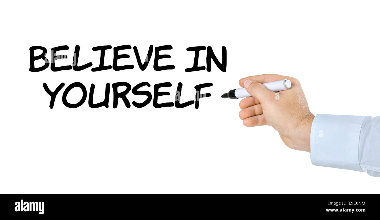 Hand with pen writing Believe in yourself Stock Photo