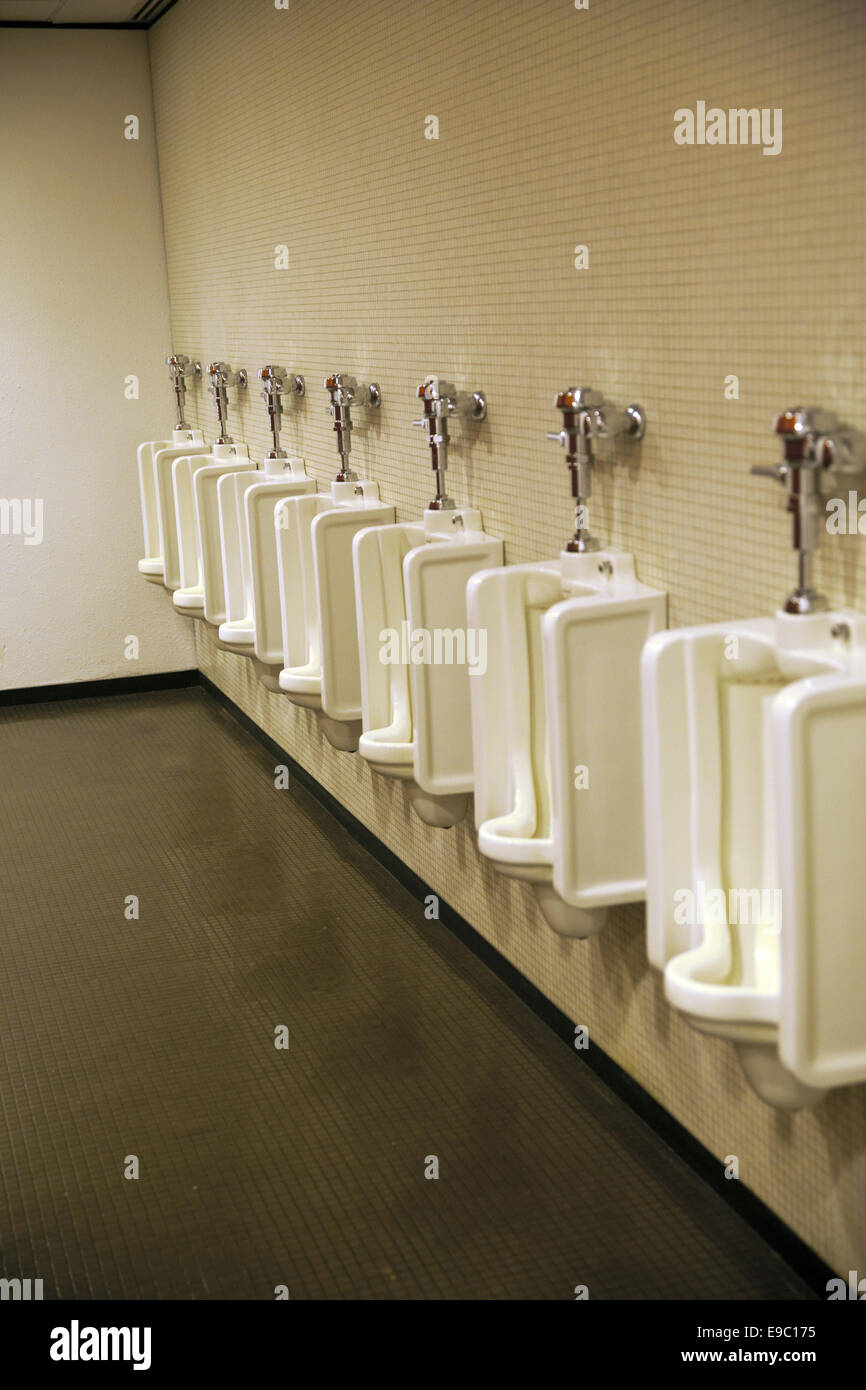 A long line of urinals in a men's bathroom in a Manhattan office