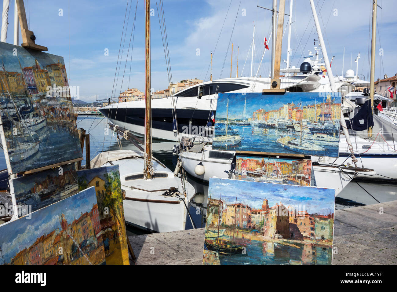 Artist selling paintings in the vieux port / old harbour of  Saint-Tropez along the French Riviera, Var, Alpes-Maritimes, France Stock Photo