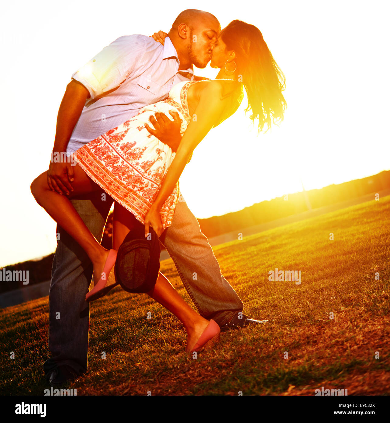 Couple kissing romantically during sunset Stock Photo