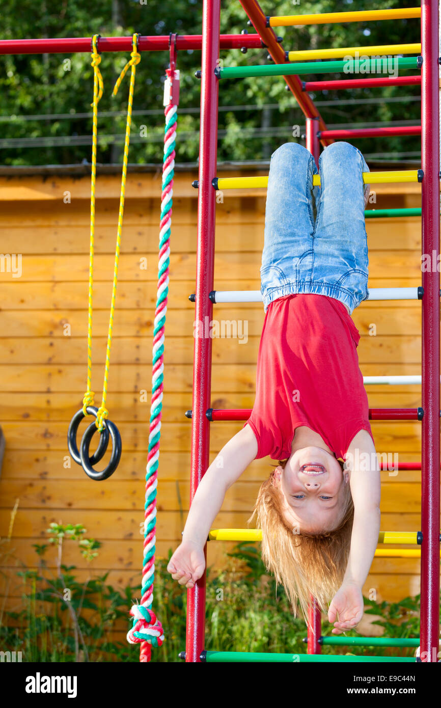 Little girl having fun playing on monkey bars Stock Photo Alamy