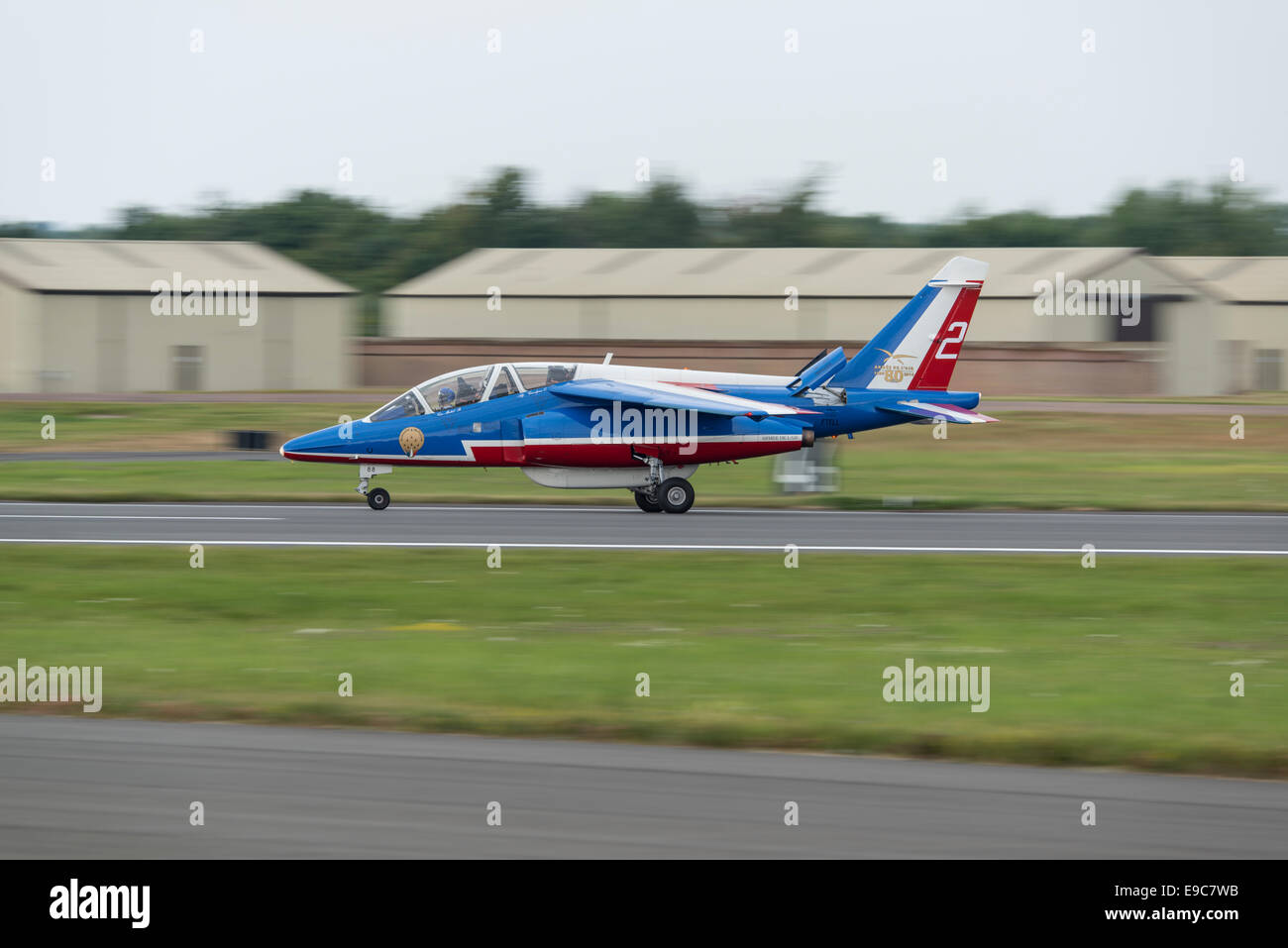 An Alpha Jet military jet trainer of the French aerobatic display team La Patrouille De France lands at the RIAT Stock Photo