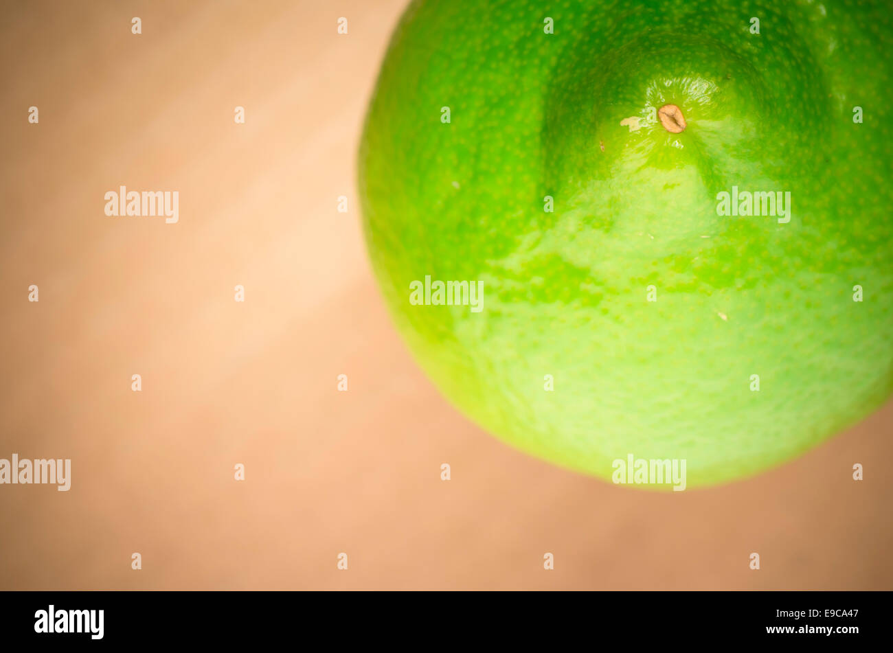 green lemon on a cardboard surface Stock Photo Alamy