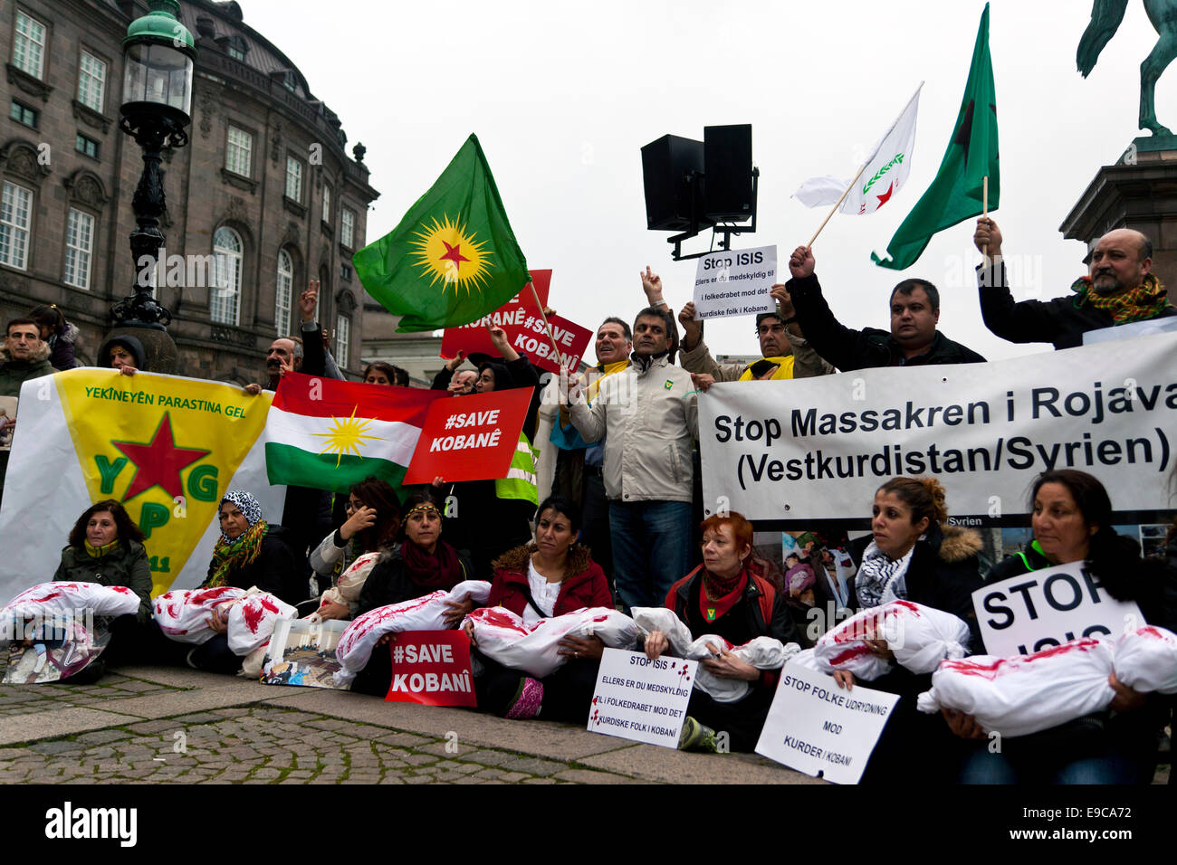 Copenhagen, Denmark. 24th Oct, 2014. Kurds at the parliament square in Copenhagen protest against Turkish inaction towards Islamic State's warfare in Kobani. Foreground, women holding blood stained body bags symbolizing the killed children in Kobani, the ultimate victims of the war Credit:  OJPHOTOS/Alamy Live News Stock Photo