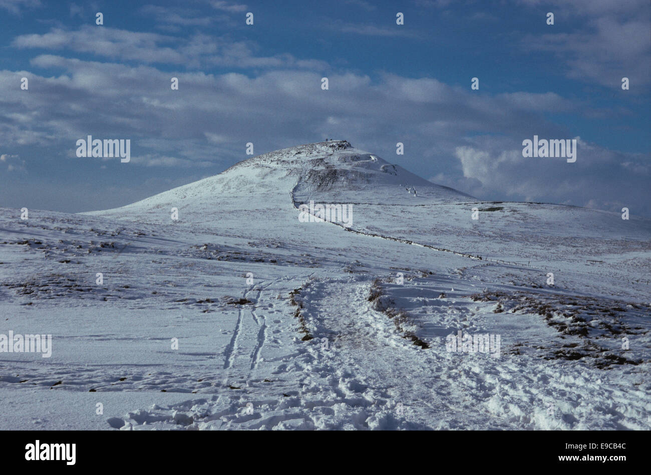 Shutlingsloe hill covered in snow near Wildboarclough Macclesfield in the Peak District.  There is a track in the foreground. Stock Photo