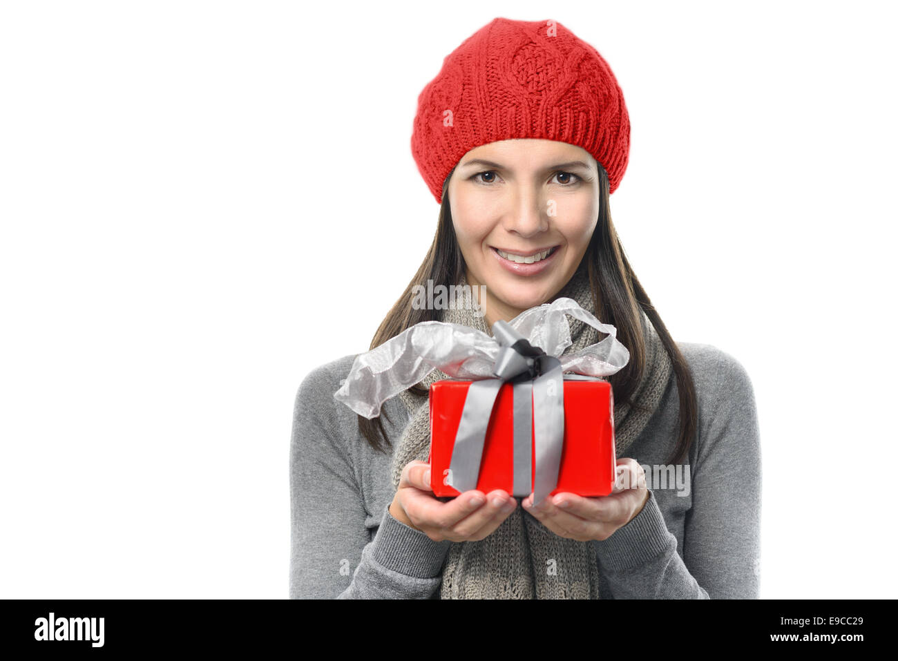 Close up Pretty Young Woman Holding Red Present Box with Gray Ribbons. Looking at Camera, isolated on White Stock Photo
