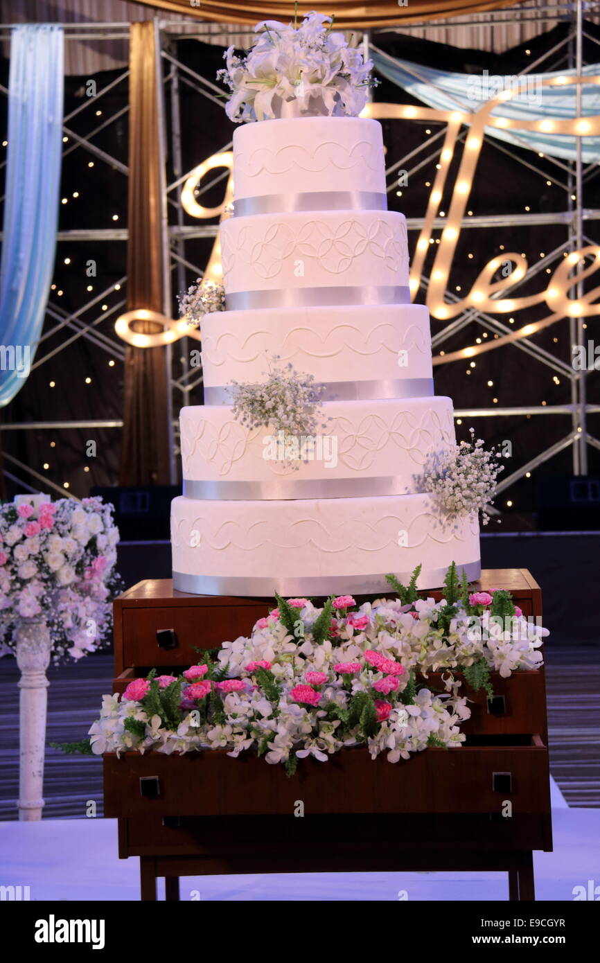 Beautiful wedding cake in white with five different levels. Stock Photo