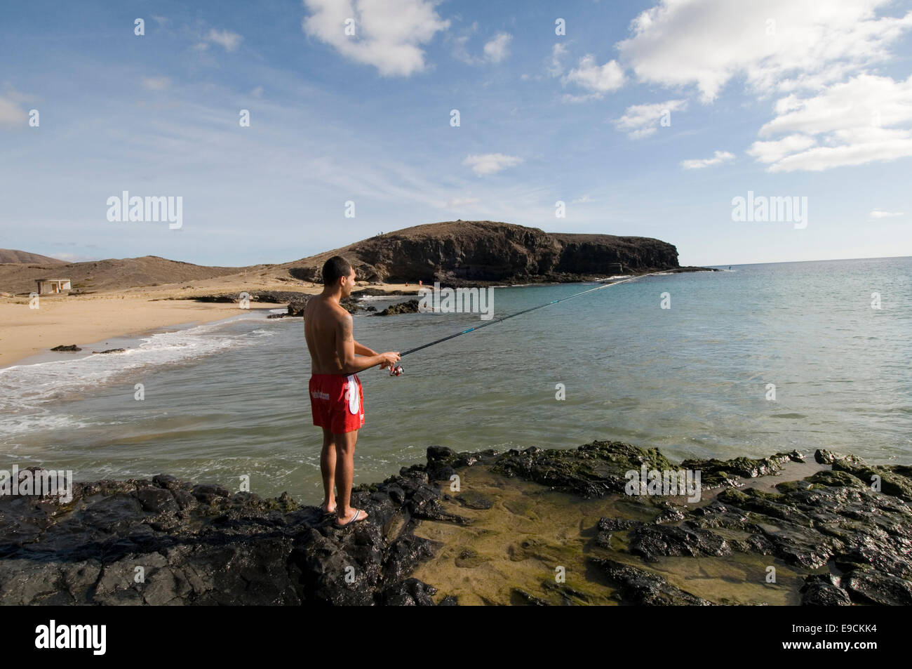 sea fishing rod man boy fish fisherman line caught hobby pastime pastimes hobbies from rocks lanzarote canary islands canaries i Stock Photo