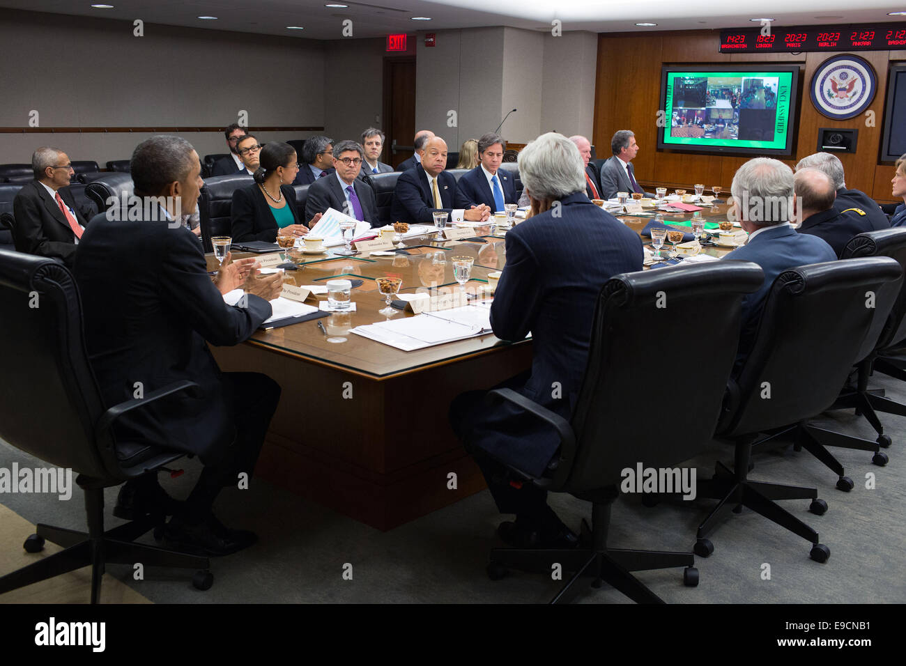 US President Barack Obama, with Secretary of State John Kerry and other cabinet members, participates in a secure video teleconference with the U.S. Embassy Baghdad and Consulates General in Erbil and Basrah, at the Department of State October 24, 2014 in Washington, DC. Stock Photo