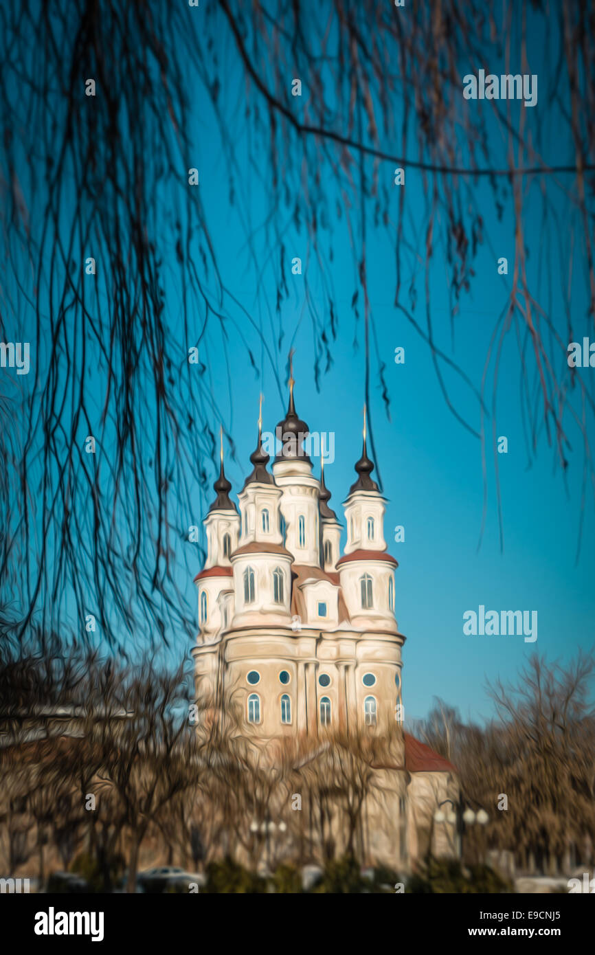 Beautiful Orthodox church with five domes through branches of tree. Winter nature. Kaluga, Russia. Stock Photo