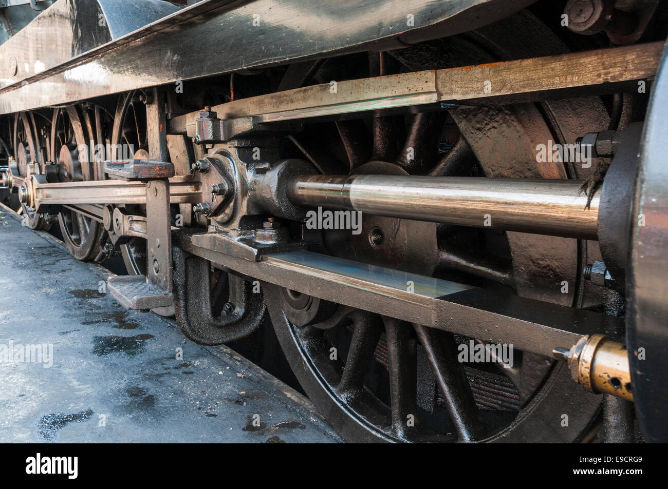 Closeup of the wheels, connecting rods and pistons of a steam