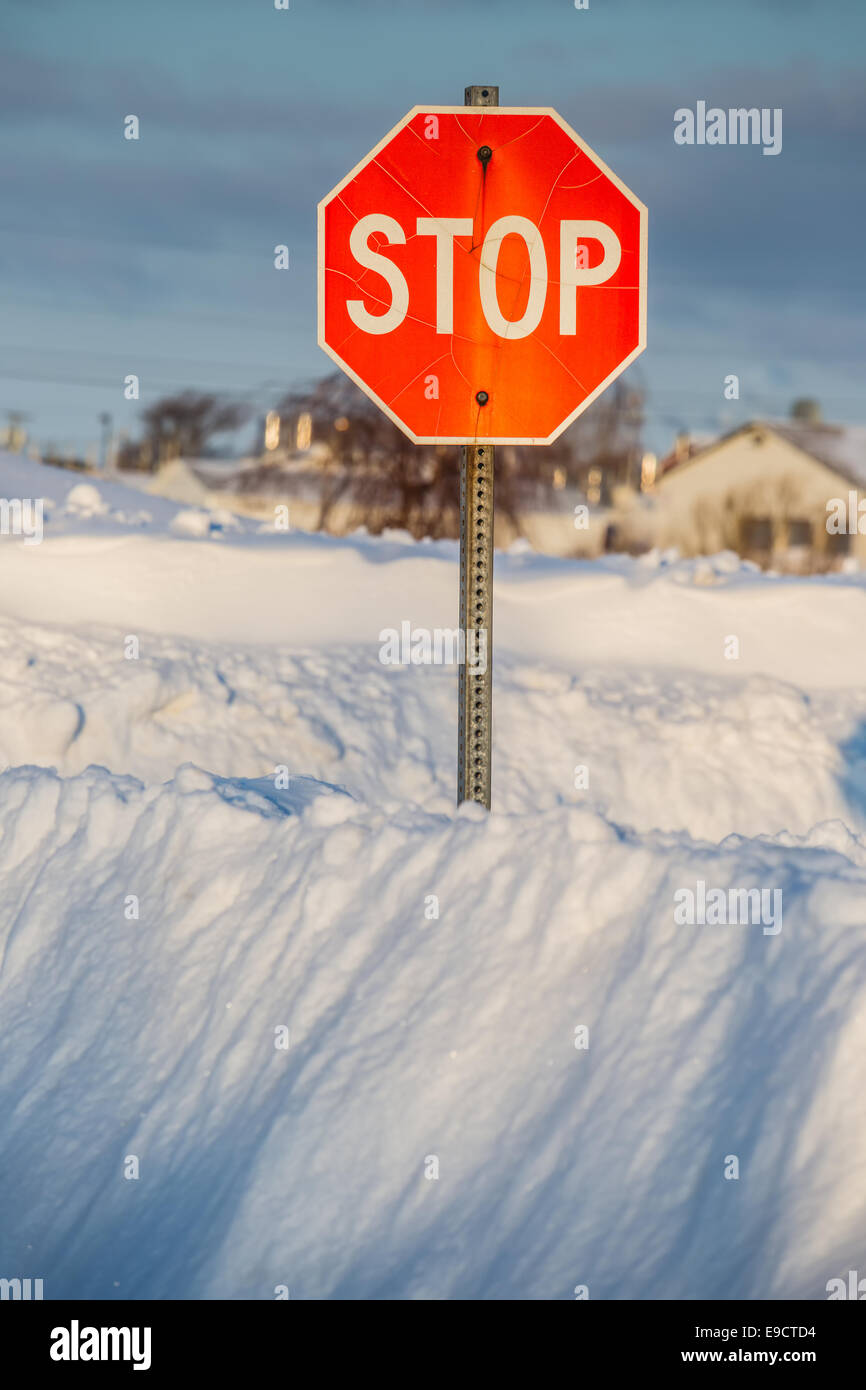 A stop sign  buried in a deep snow bank. Stock Photo